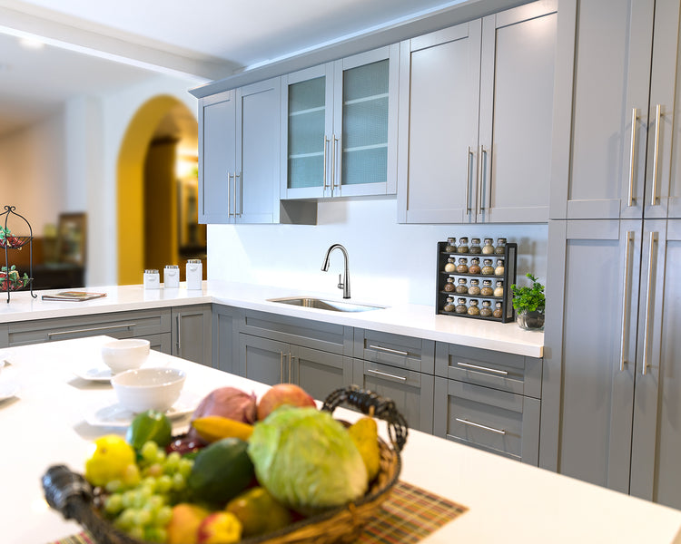 White countertops and grey RTA shaker cabinets installed in a kitchen