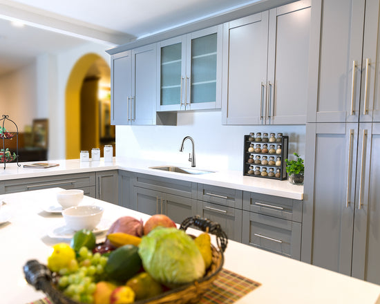 White countertops and grey RTA shaker cabinets installed in a kitchen